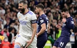 Real Madrid's French forward Karim Benzema (L) celebrates scoring his team's third goal during the UEFA Champions League semi-final second leg football match between Real Madrid CF and Manchester City at the Santiago Bernabeu stadium in Madrid on May 4, 2022.