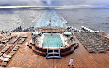 A passenger walks in a deck of the Cunard cruise liner RMS Queen Mary 2 sailing in the Atlantic ocean