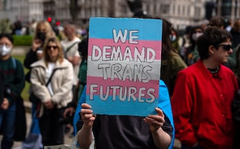 Trans rights activists take part in a protest against the ban on hormone blockers in London