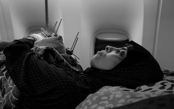 A woman lies down on the plane