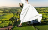 Bride running through countryside
