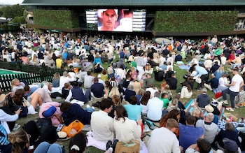 Spectators watch a men's doubles match involving Britain's Andy Murray and Jamie Murray on July 4, 2024 