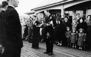 Lieutenant Michael Fulford-Dobson, centre, reading the commissioning warrant of HMS Dark Avenger