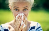 Portrait of girl blowing her nose