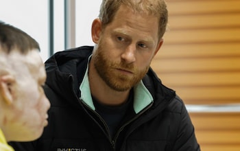 Prince Harry talks to a person wounded in the war in Ukraine during his unannounced visit to Lviv