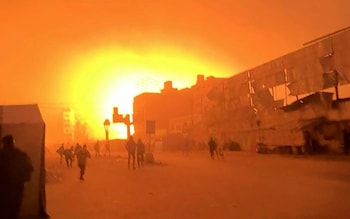 Flames rise after an airstrike on Al-Ahli hospital