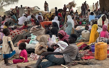 Displaced people rest in a makeshift encampment in an open field near the town of Tawila in war-torn Sudan's western Darfur region
